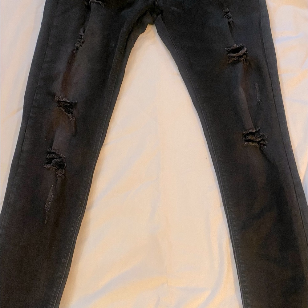 Black distressed slim straight jeans.